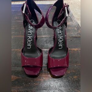 Calvin Klein Women's Marinda patent leather ankle strap heels.